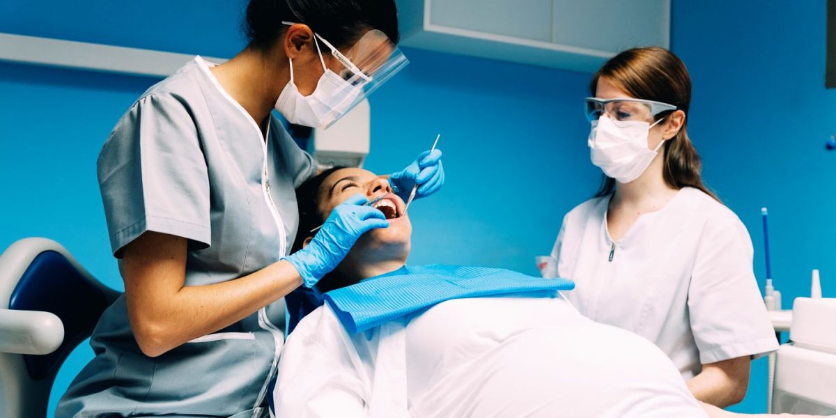 dentists-with-a-patient-during-a-dental-interventi-2021-08-27-22-49-32-utc-min.jpg
